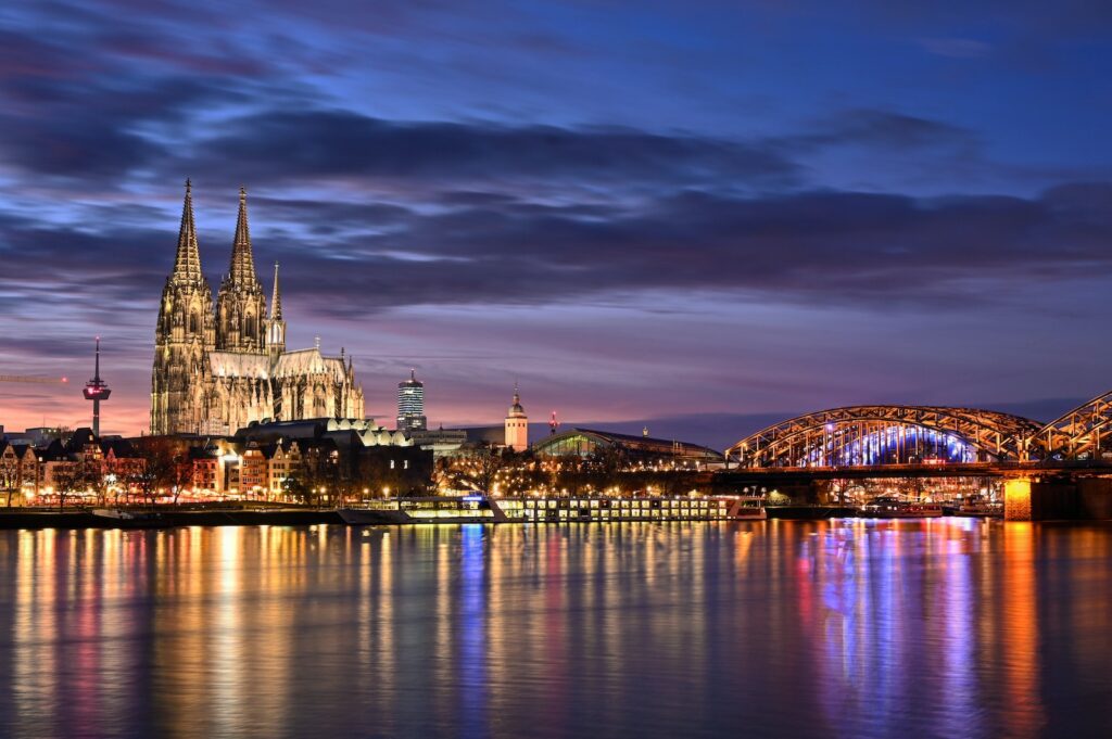 lighted city buildings near body of water